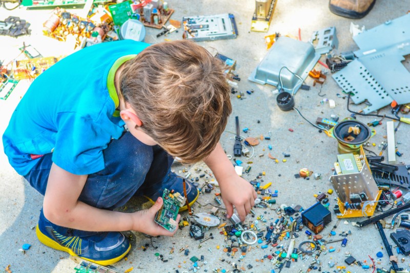 Child playing with cluttered toys